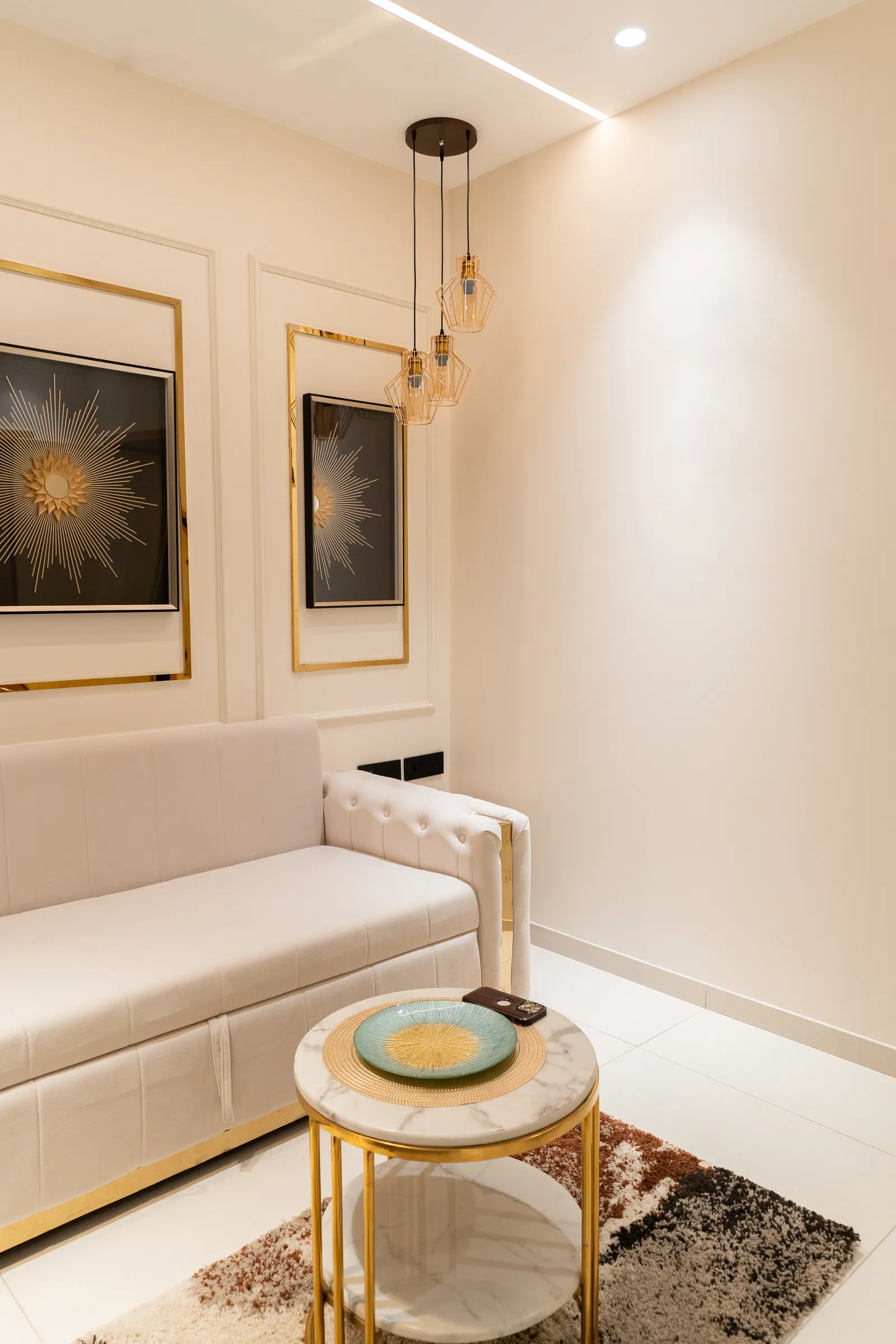 Seating nook with cream sofa, pendant light and starburst art — Abhishek's Residence